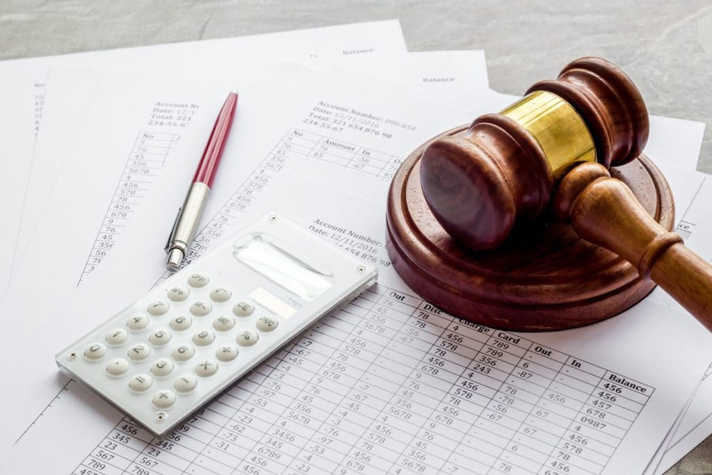A gavel, calculator, and pen on financial documents | Bankruptcy Lawyer | Natural State Law, PLLC
